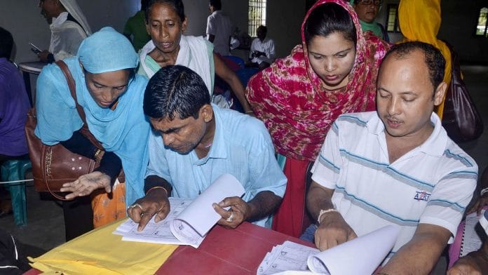 People check their names on the NRC final list at a NRC centre in Buraburi Gaon, Morigaon.