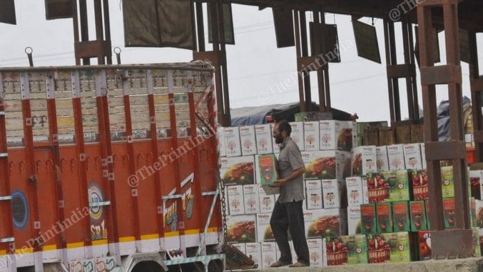 An apple seller in Kashmir loads produce to be shipped across the country. | Photo: Praveen Jain | ThePrint