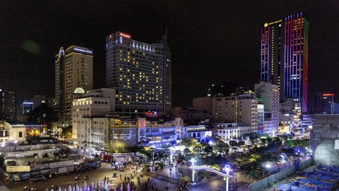 Commercial buildings in downtown district being illuminated at night in Ho Chi Minh, Vietnam | Photographer: Ore Huiying | Bloomberg