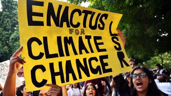 Protesters hold a placard during the global climate strike in New Delhi Friday. | ANI