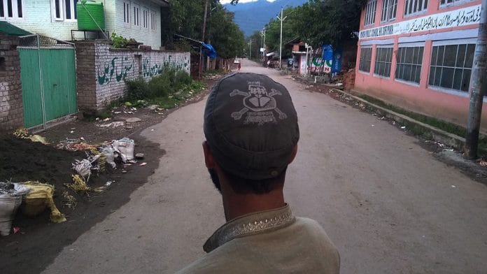 A college student who teaches the local kids looks at the empty roads to famous hill station Pahalgam