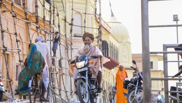 Ayodhya residents pass through the Ram Ki Paidi (Ram's birthplace) area on the last day of Ram Janmabhoomi hearings in SC | PTI