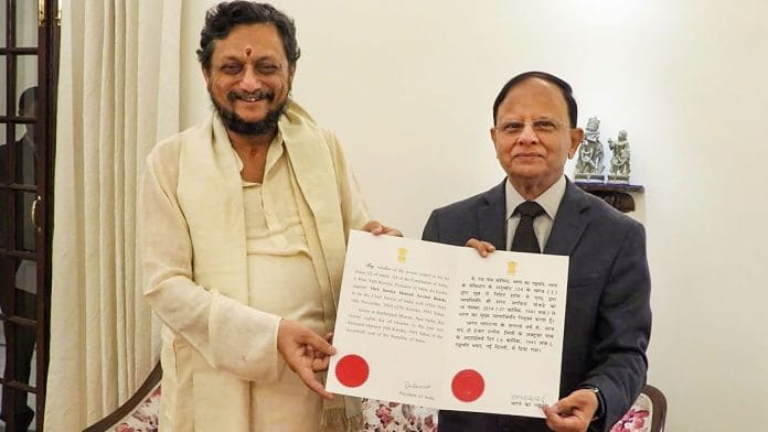 PK Mishra presents the warrant of appointment to Chief Justice of India-designate Justice Sharad Arvind Bobde in New Delhi