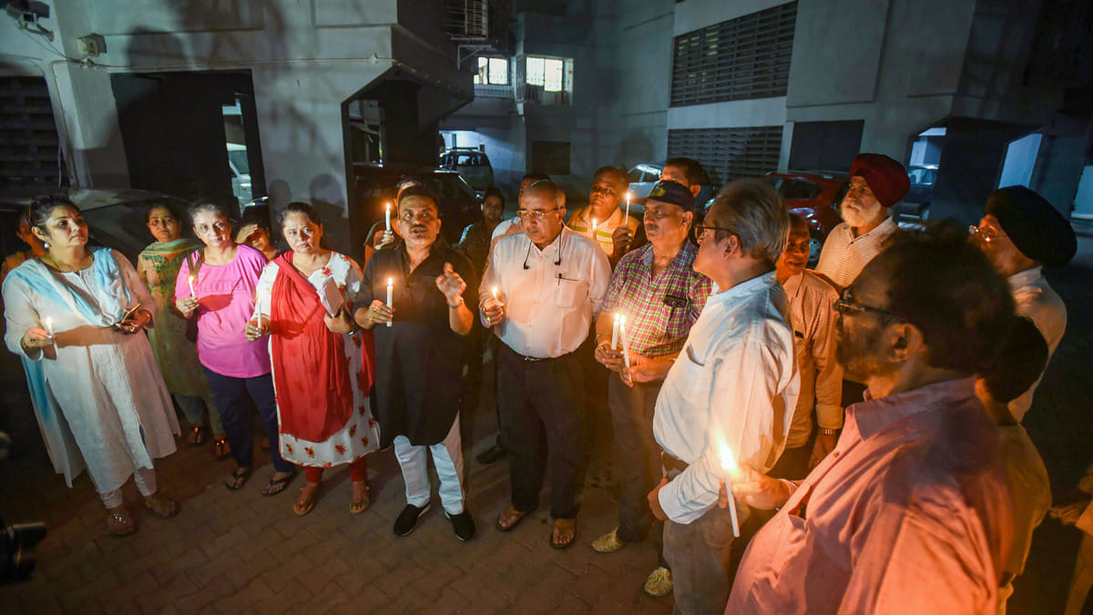 Mumbai Congress leader Sanjay Nirupam speaks as PMC depositors participate in a candlelight march for late Sanjay Gulati, at Andheri in Mumbai. | PTI
