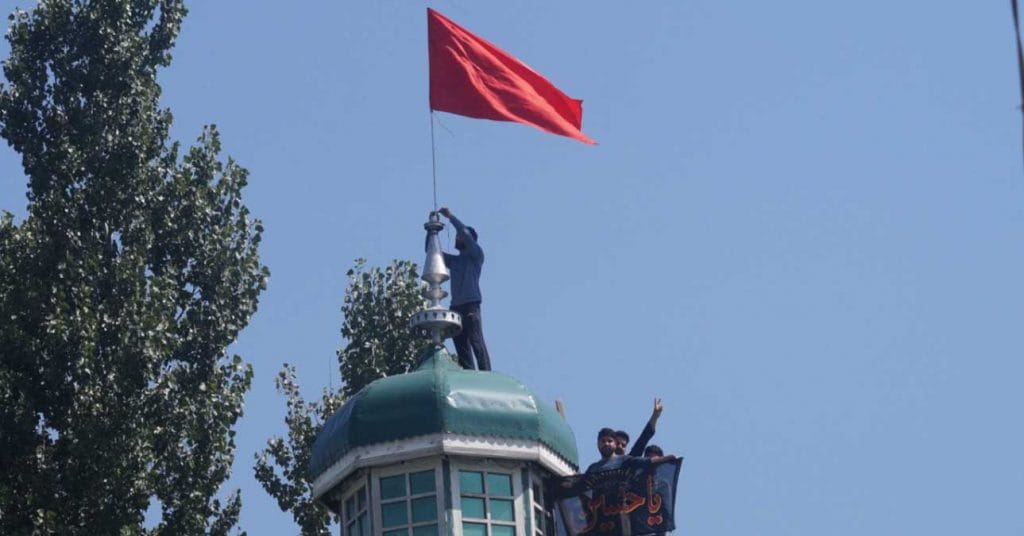 People raise red flags on an Imambara in Budgam, Kashmir | Sajid Ali