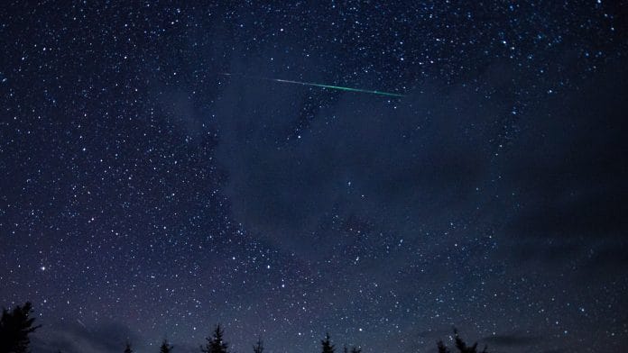 In this 20 second exposure, a meteor streaks across the sky during the annual Perseid meteor shower