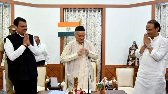 Maharashtra Governor Bhagat Singh Koshyari flanked by state CM Devendra Fadnavis and deputy CM Ajit Pawar during an oath-taking ceremony in Mumbai on 23 Novermber