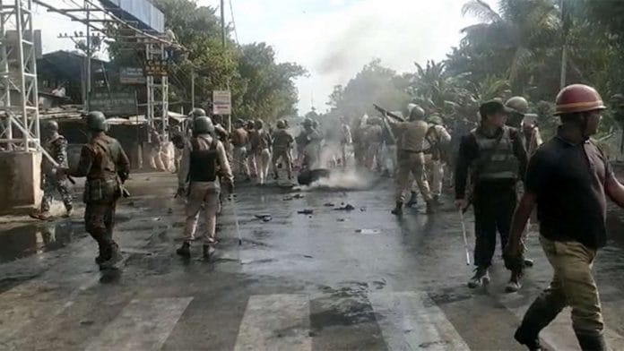 Security personnel fire in the air during a protest march against the Citizenship (Amendment) Bill, at Bokel, in Dibrugarh on 11 December