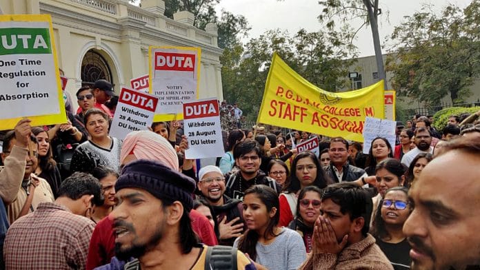 Delhi University Teachers' Association (DUTA) members hold placards and shout slogans during a protest outside DU Vice-Chancellor's office demanding rollback of Aug 28 circular which stops the appointment of ad-hoc teachers, in New Delhi on Wednesday. | ANI