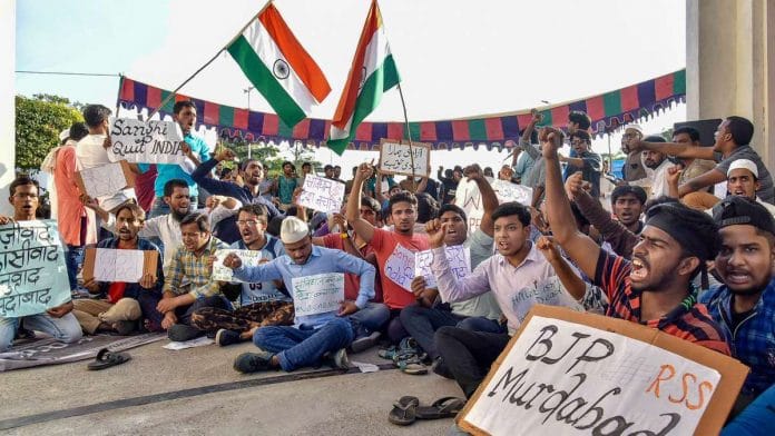 Maulana Azad National Urdu University students hold placards during a protest in front of the university entrance against Citizenship (Amendment) Act (CAA) and NRC, in Hyderabad,