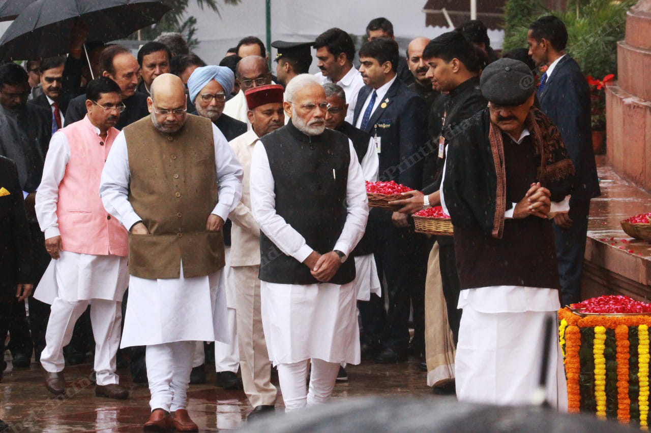 From left to right, Amit Shah, Narendra Modi and Venkaiah Naidu line up to pay floral tributes
