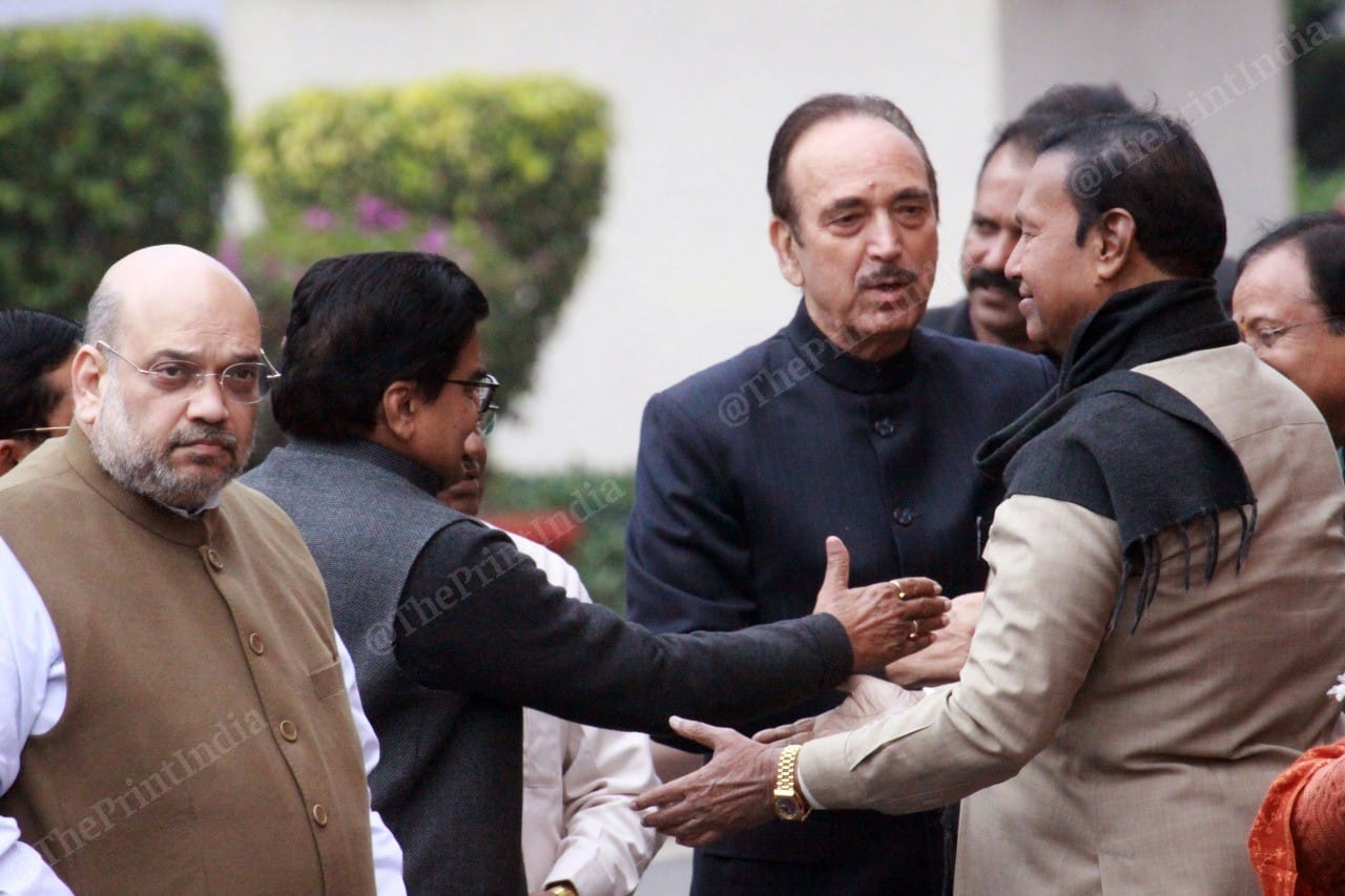 Amit Shah (extreme left) stands while Rajya Sabha MP Ram Gopal Yadav (left), Congress leader Ghulam Nabi Azad (centre) and DMK MP T. R. Baalu (right) greet each other| Photo: Praveen Jain | ThePrint