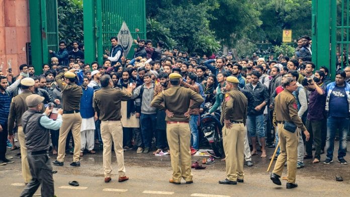 Students of Jamia Millia Islamia University clash with the police during a protest against the Citizenship Amendment Bill on 13 December