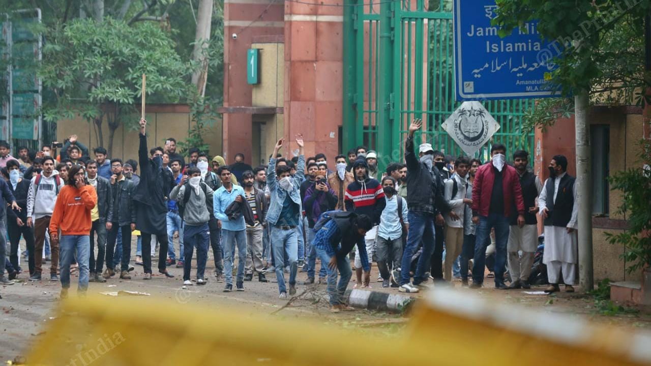 Students outside Jamia Milia Islamia University in New Delhi on 13 December