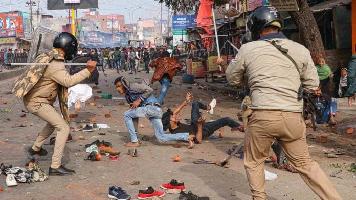 Police personnel baton charge at protestors during their rally against NRC and amended Citizenship Act in Lucknow on 19 December
