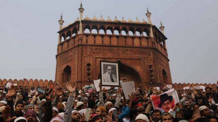 The crowd at Jama Masjid protesting against Citizenship Amendment Act, holding the photo of BR Ambedkar | Photo: Manisha Mondal | ThePrint