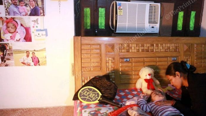 14-month-old Champak is being taken care of by her aunt, in Varanasi