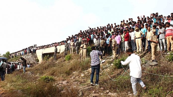 People and police officials gather at the spot where the accused in the rape and murder of a young veterinarian were killed in an encounter in Hyderabad Friday. | Photo: ANI