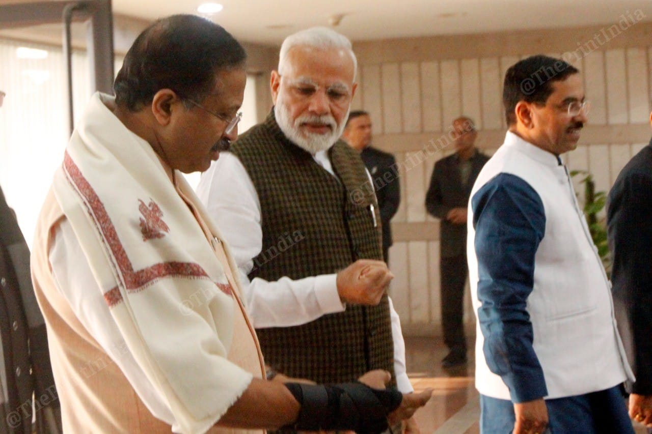 Sequence image 1. Prime Minister Narendra Modi gives physiotherapy tips to MoS V. Muraleedharan | Photo: Praveen Jain | ThePrint