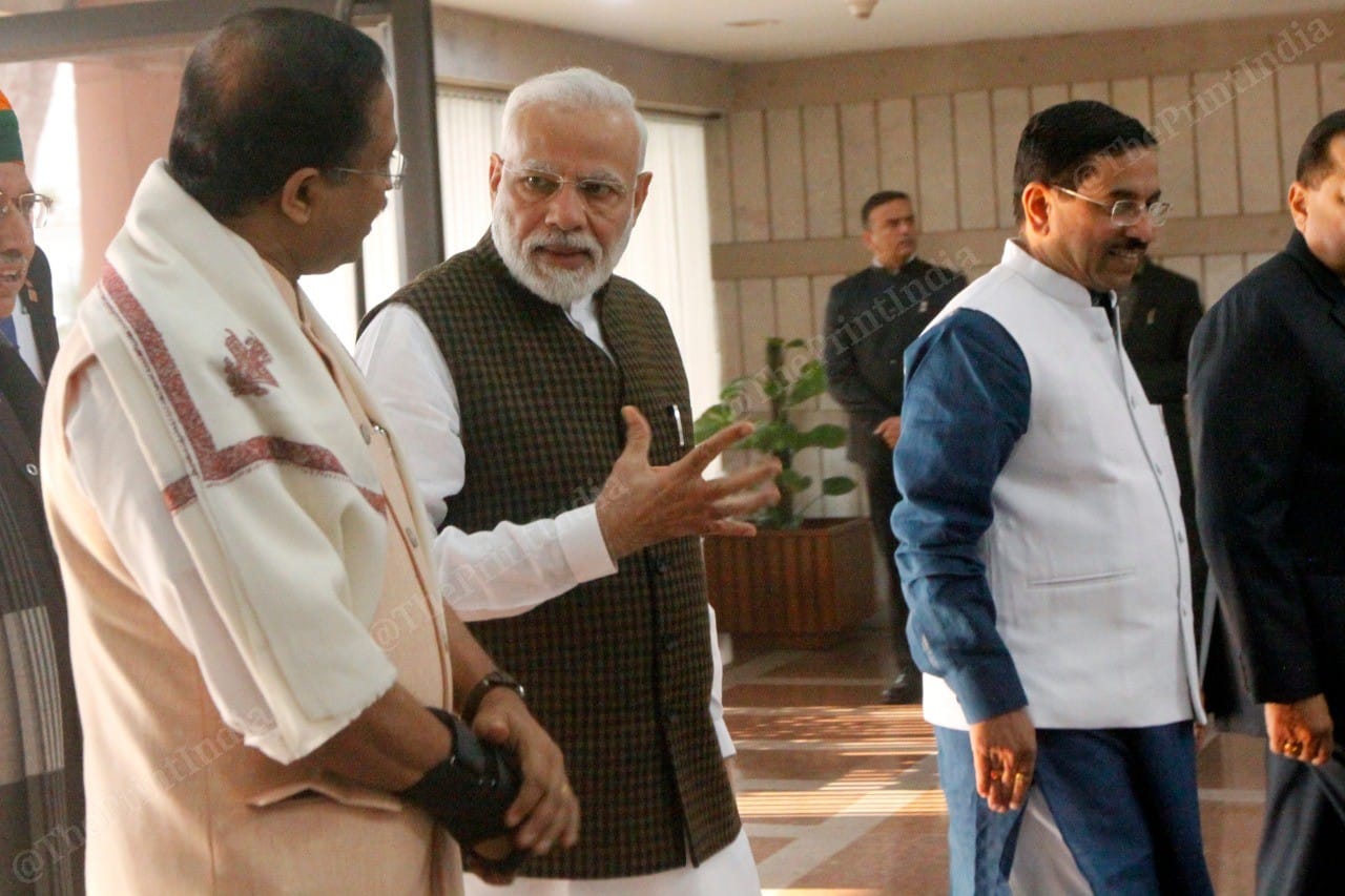 Sequence image 2. Prime Minister Narendra Modi shows some flexing exercise to MoS V. Muraleedharan | Photo: Praveen Jain | ThePrint