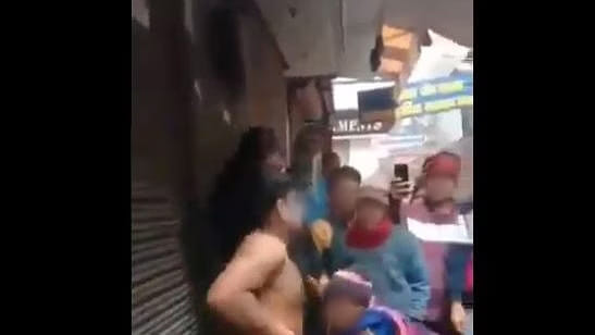 Screengrab from a viral video of a man being stripped naked and beaten up | Photo: Twitter
