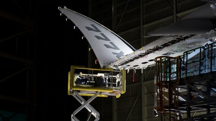 A work platform sits under the folding wingtip of a Boeing Co. 777X airplane while under production at a manufacturing facility in Everett, Washington | Bloomberg