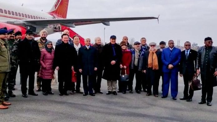 DSP Davinder Singh (in turban behind envoy in red jacket) at Srinagar airport where he met envoys from 15 countries Thursday | PTI