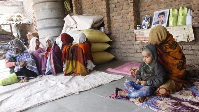 The family of 9-year Joginder (photo at back) who died in Kota's JK Lon Hospital after none of the 2 ventilators worked | Photo: Praveen Jain | ThePrint