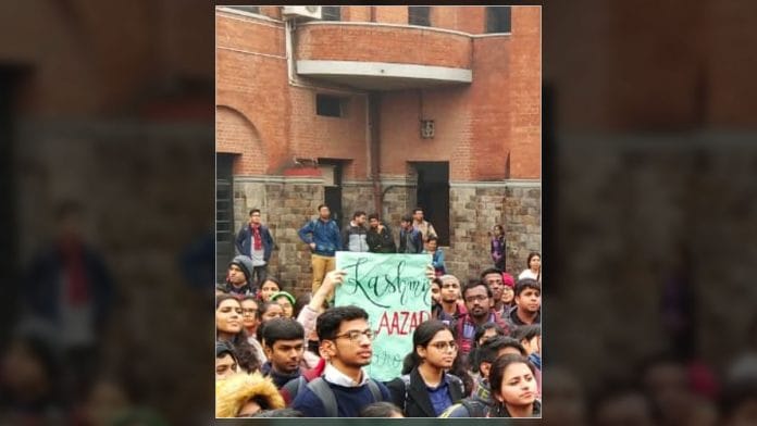 A student holds up a 'Free Kashmir' poster at a protest in St. Stephen's college, New Delhi. | Twitter