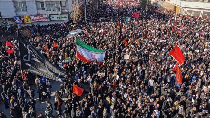 Iranian mourners gather for the burial of slain top general Qasem Soleimani in his hometown Kerman | Photo by ATTA KENARE/AFP via Getty Images | Bloomberg