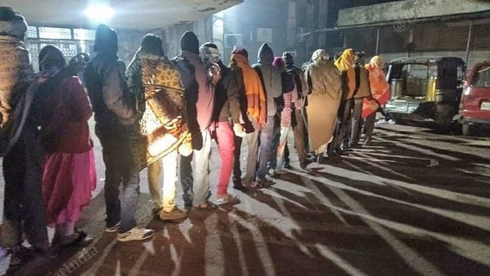 Family members of children admitted in the JK Lon Hospital, waiting in a queue for food. | Photo: Praveen Jain/ThePrint