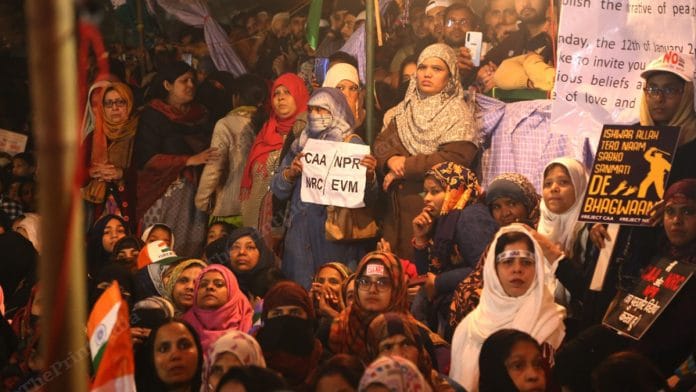 Protesters at Delhi's Shaheen Bagh holding placards against the CAA, NPR and NRC
