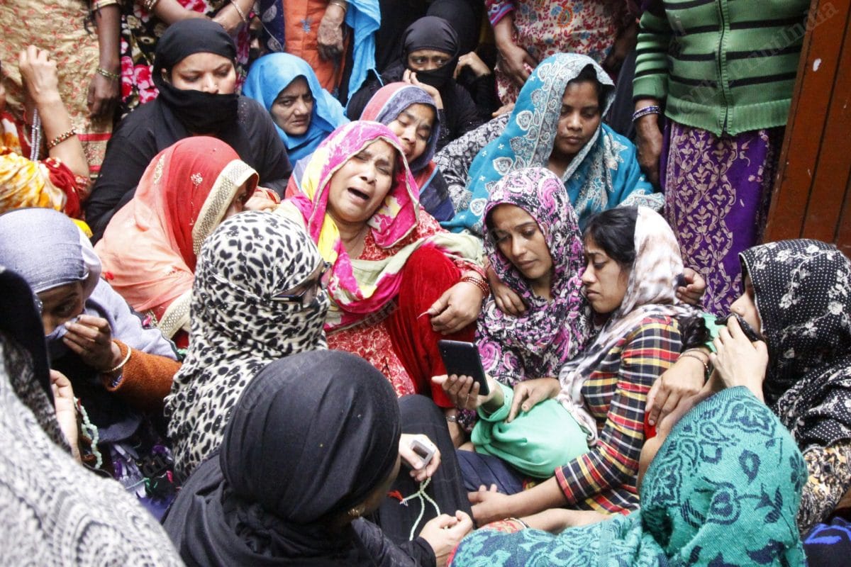 Asgari, mother of Amir and Hashim, is inconsolable. Grief- stricken, their sisters—Nagma and Rehna, look at the photos of their brothers on their mobile phone, while they await their bodies | Photo: Praveen Jain | ThePrint