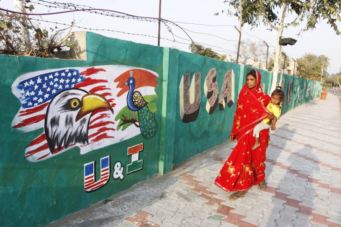 A woman passes by the the wall that is being constructed in Ahmedabad before Trump's visit to India | Photo: Praveen Jain | ThePrint 