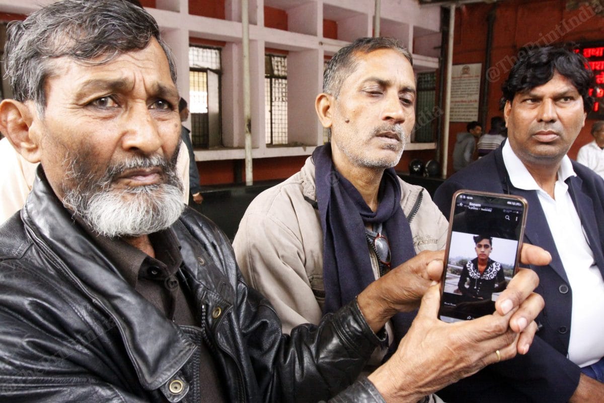 A relative of the two brothers shows Hashim’s photo on his mobile phone at their residence at GTB hospital | Photo: Praveen Jain | ThePrint