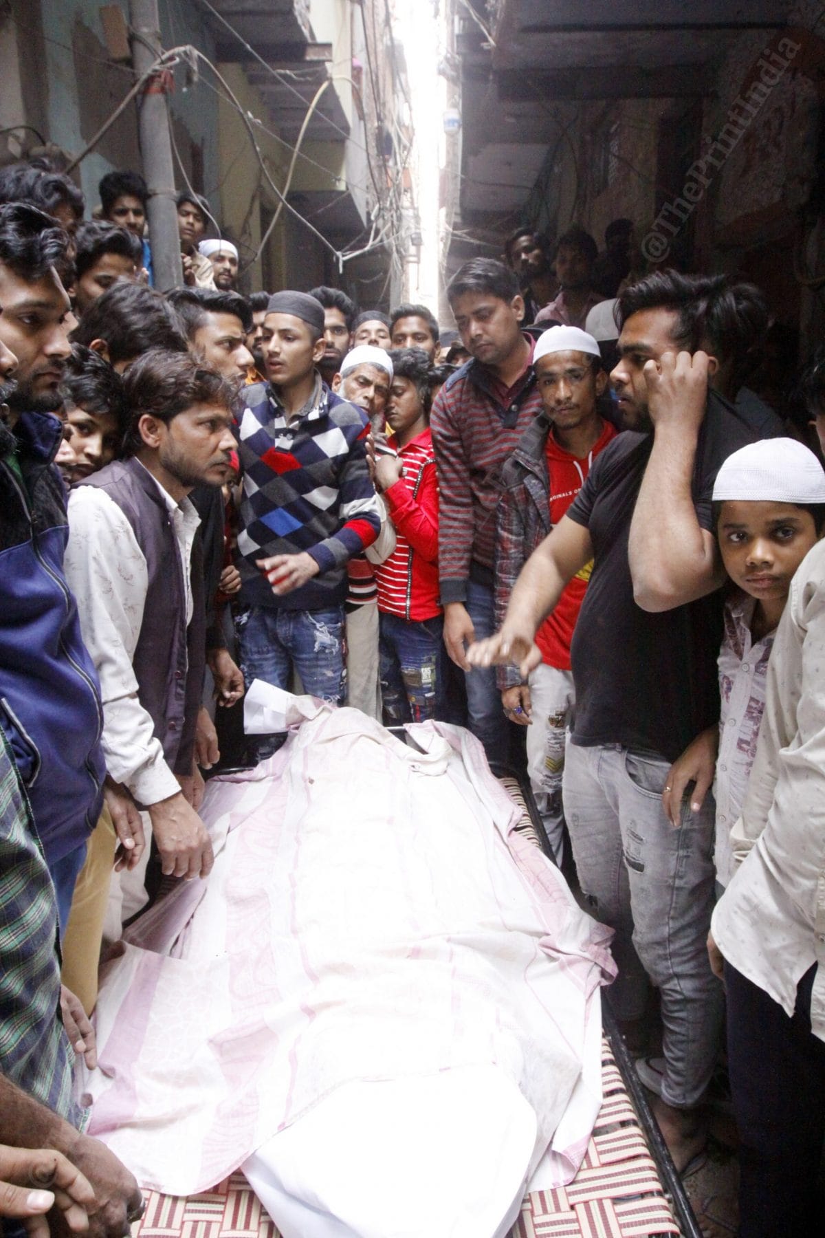 People preparing for the Janaza. The bodies are wrapped in a sacred cloth, put in the coffin and then begins their last journey | Photo: Praveen Jain | ThePrint