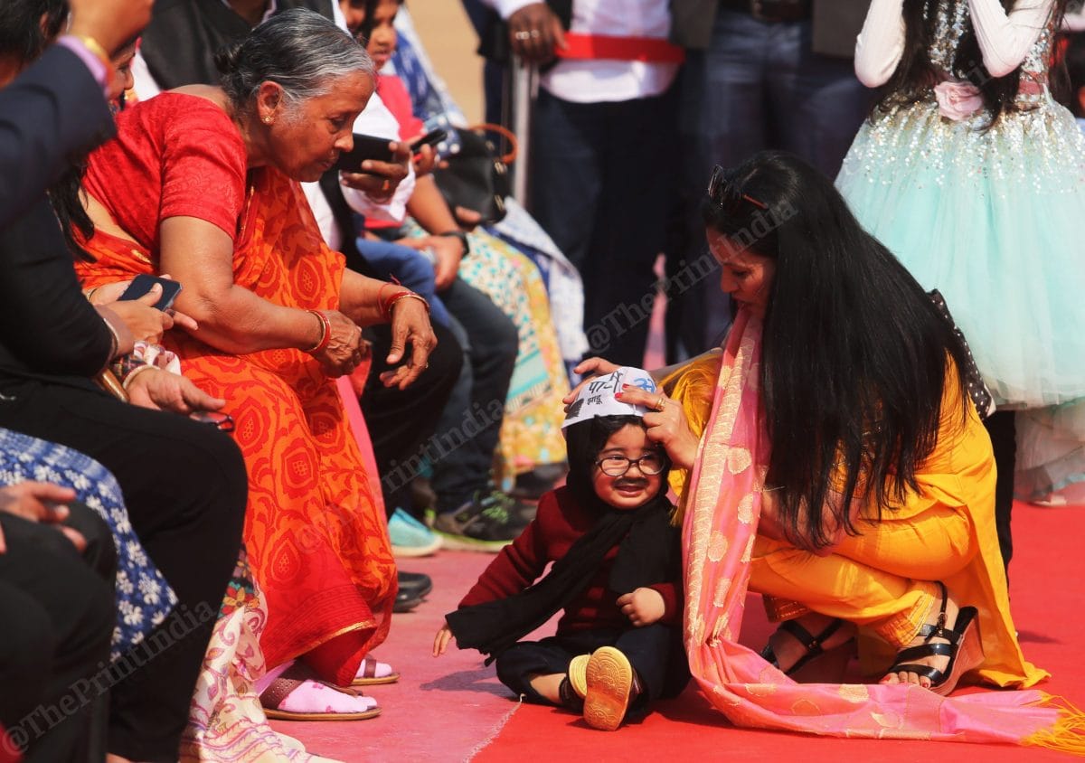 Arvind Kejriwal's mother Gita Devi in orange saree plays with baby Kejriwal while his mother takes care of him | Photo: Manisha Mondal | ThePrint