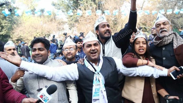 AAP suppoters cheering at AAP office in New Delhi Tuesday