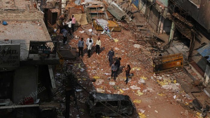 People try to salvage what they can from the destroyed property in Shiv Vihar | Photo: Manisha Mondal | ThePrint