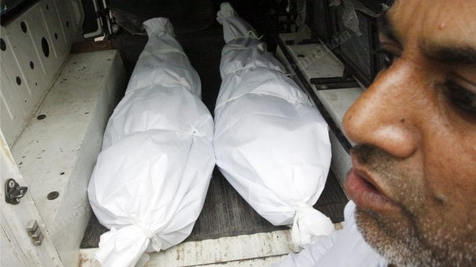 Bodies of Amir and Hashim, kept in a van after the postmortem was conducted at GTB Hospital Saturday. A relative makes arrangements to take the bodies back home | Photo: Praveen Jain | ThePrint