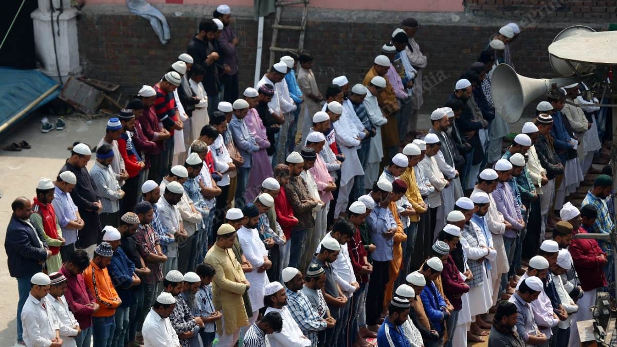 People offer Friday namaz on the roof of a mosque that was burnt by rioters in Brijpuri | Photo: Suraj Singh Bisht | ThePrint