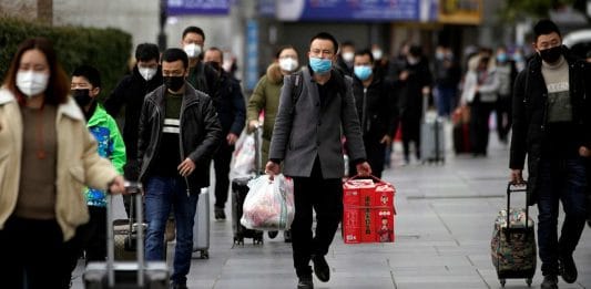 People in masks outside the Shanghai railway station
