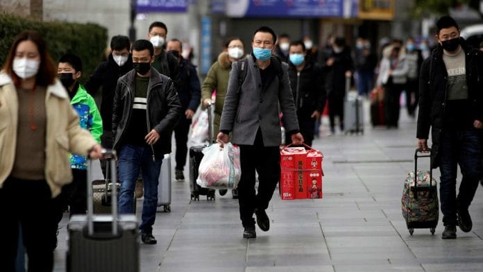 People in masks outside the Shanghai railway station