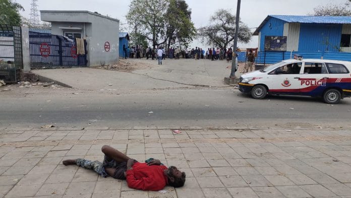 A man lies motionless outside Yamuna Pushta night shelter in Delhi | Simrin Sirur | ThePrint