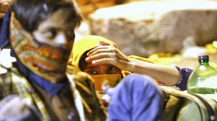 Three pregnant women sitting during the night waiting for conveyance | Photo: Praveen Jain | ThePrint