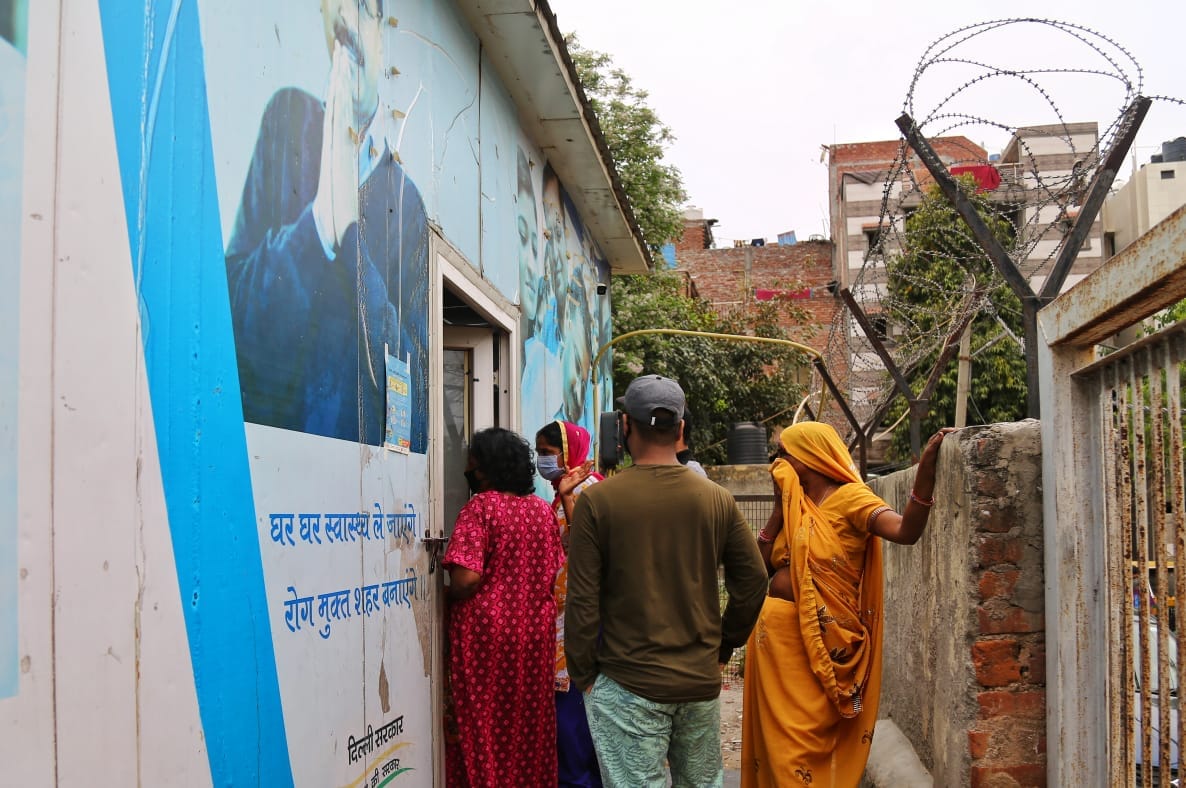 A group of patients gathers at the door of a mohalla clinic in Dakshin Puri