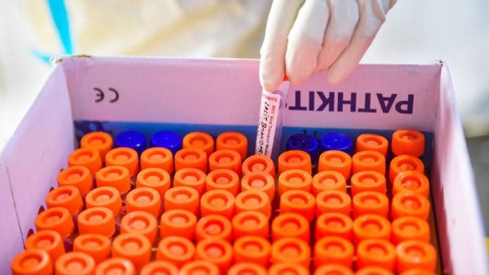 A health worker sorts samples obtained from passengers for the Covid-19 test at Nizamuddin Railway Station in New Delhi, on 25 November 2020 | Kamal Kishore | PTI