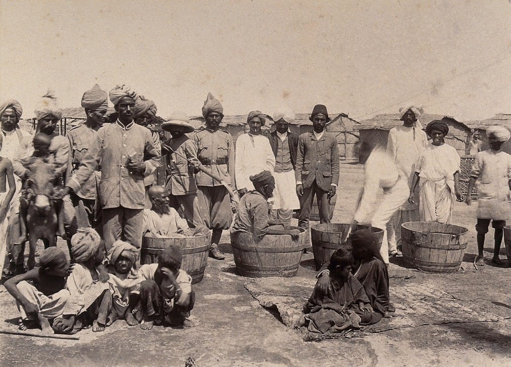 Authorities disinfecting plague patients in wooden tubs, Karachi, 1897. | Wellcome Library archive collection