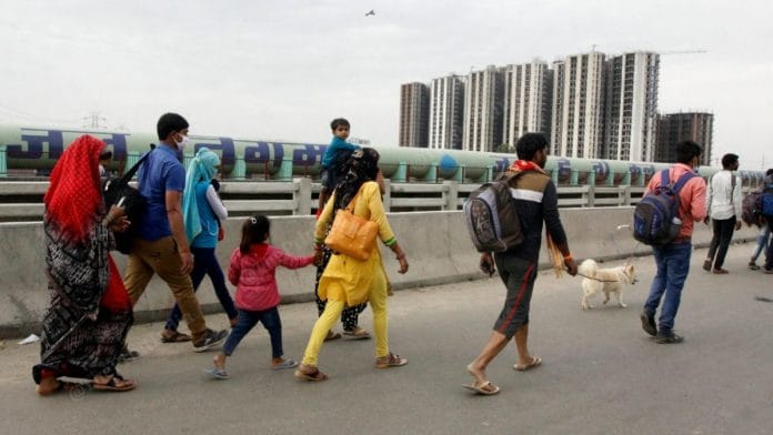 People walk back to their villages along the Delhi-Meerut Expressway. The lockdown has shut all means of interstate public transport | Praveen Jain | ThePrint