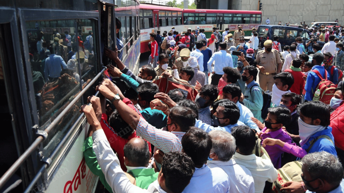 A crowd of migrant workers gather around the UPSRTC buses near the Delhi=Ghaziabad border | Photo : Suraj Singh Bisht | ThePrint